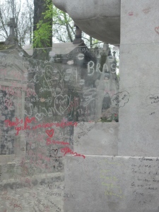 Graffiti on the glass barrier at Oscar Wilde's tomb, Père Lachaise, Paris - May 2012